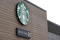 A sign at a Starbucks Coffee store in south Seattle is shown, Tuesday, Oct. 27, 2020. Starbucks saw faster-than-expected recovery in the U.S. and China in its fiscal fourth quarter, giving it confidence as it heads into the holiday season. (AP Photo/Ted S. Warren)