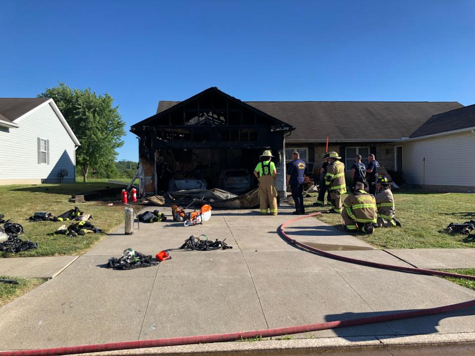 Massillon firefighters examine what's left of a garage at 4573 Evangel Ave. NW after a fire destroyed the garage and two vehicles and killed a cat.