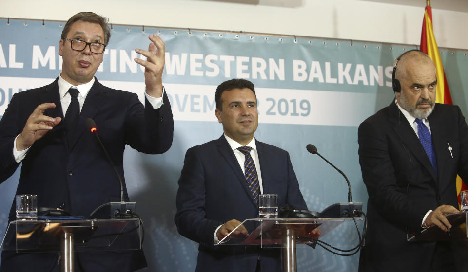 Serbia's President Aleksandar Vucic, left, talks in presence of North Macedonia's Prime Minister Zoran Zaev, center and Albania's Prime Minister Edi Rama, right, during a joint news conference, following the Western Balkan leaders' meeting in the southwestern town of Ohrid, North Macedonia, Sunday, Nov. 10, 2019. Western Balkan leaders say they are committed to work closely and to remove administrative barriers for free movement of goods and people between their countries. (AP Photo/Boris Grdanoski)