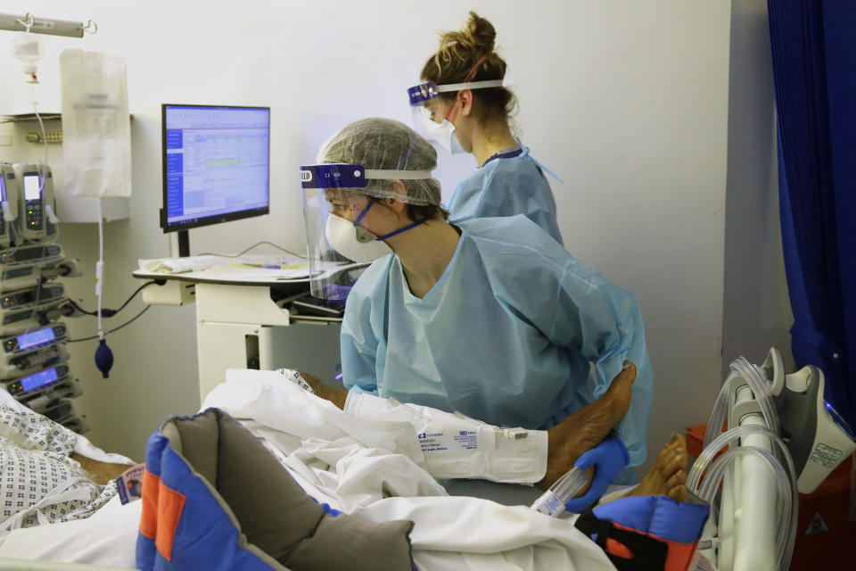 Critical Care staff treat a COVID-19 patient on the Christine Brown ward at King's College Hospital in London, Wednesday, Jan. 27, 2021. (AP Photo/Kirsty Wigglesworth, Pool)