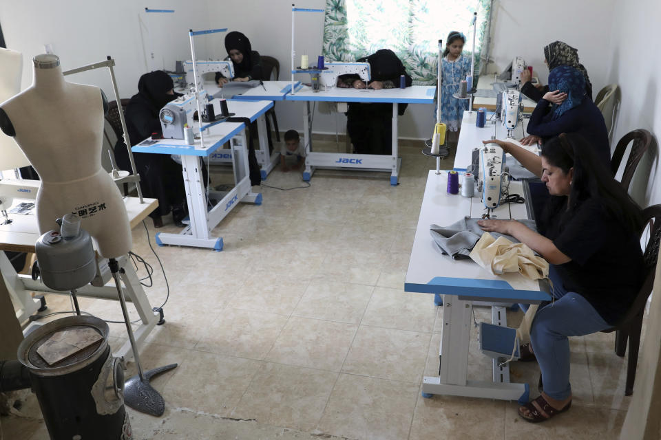 In this Monday, June 17, 2019 photo, Syrian refugees work sewing at a workshop in the town of Bar Elias, Bekaa Valley, Lebanon. Authorities in Lebanon are waging their most aggressive campaign yet against Syrian refugees, making heated calls for them to go back to their country and taking action to ensure they can’t put down roots. They are shutting down shops where Syrians work without permits and ordering the demolition of anything in their squalid camps that could be a permanent home. (AP Photo/Bilal Hussein)