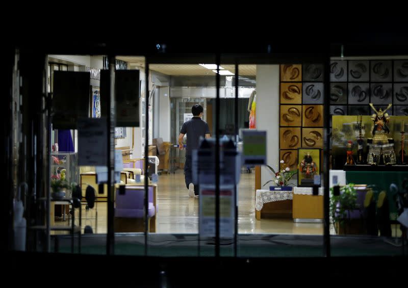 A staff member is seen inside an elderly care home where according to local media more than 40 residents and staff members have been infected with the coronavirus disease (COVID-19), in Tokyo