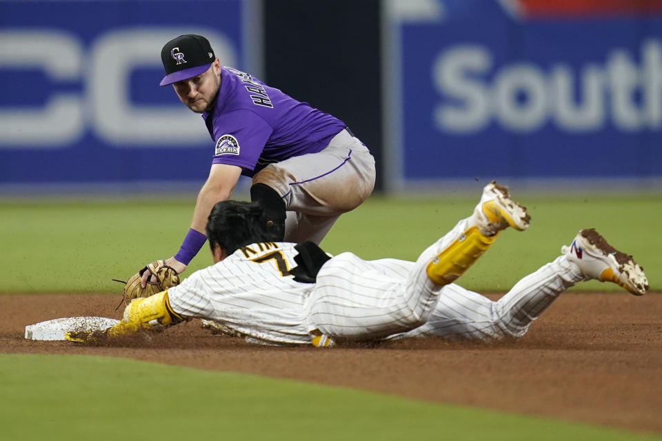 Colorado Rockies second baseman Garrett Hampson tags out San Diego Padres' Ha-Seong Kim, who was trying to stretch a single during the fourth inning of a baseball game Friday, June 10, 2022, in San Diego. (AP Photo/Gregory Bull)
