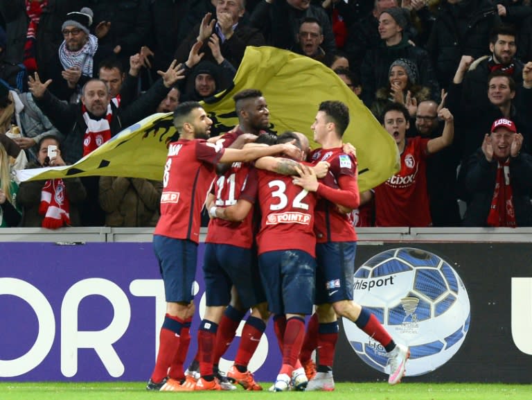 Lille's midfielder Eric Bautheac is congratulated by a teammates after scoring a goal during the French League Cup football match Lille versus Bordeaux at the Stade Pierre Mauroy stadium in Villeneuve-d'Ascq, France, on January 26, 2016