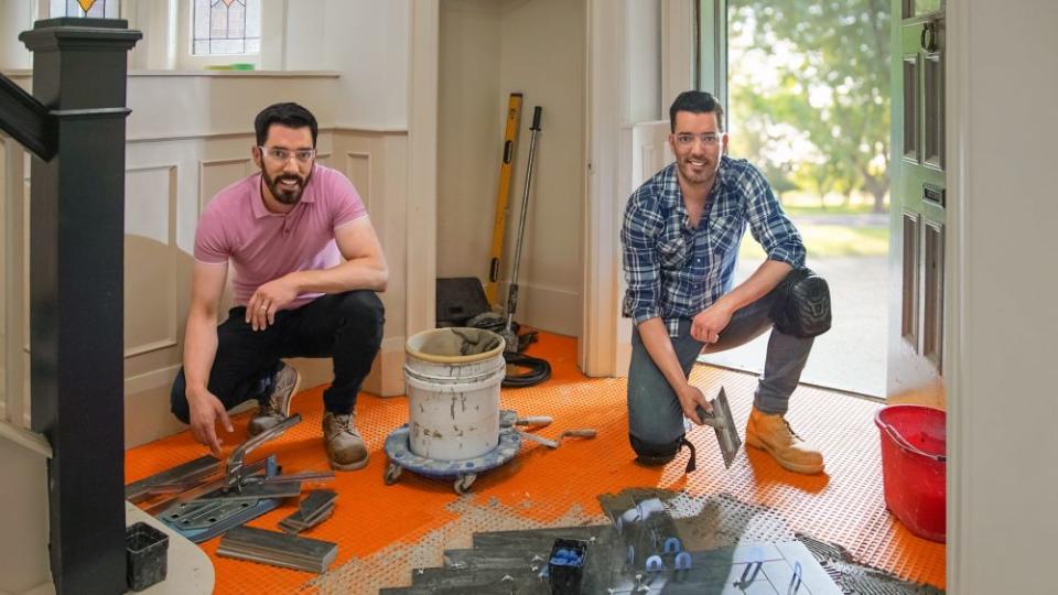 Drew and Jonathan during tile installation on Amy and Kate’s home, as seen on Property Brothers: Forever Home.