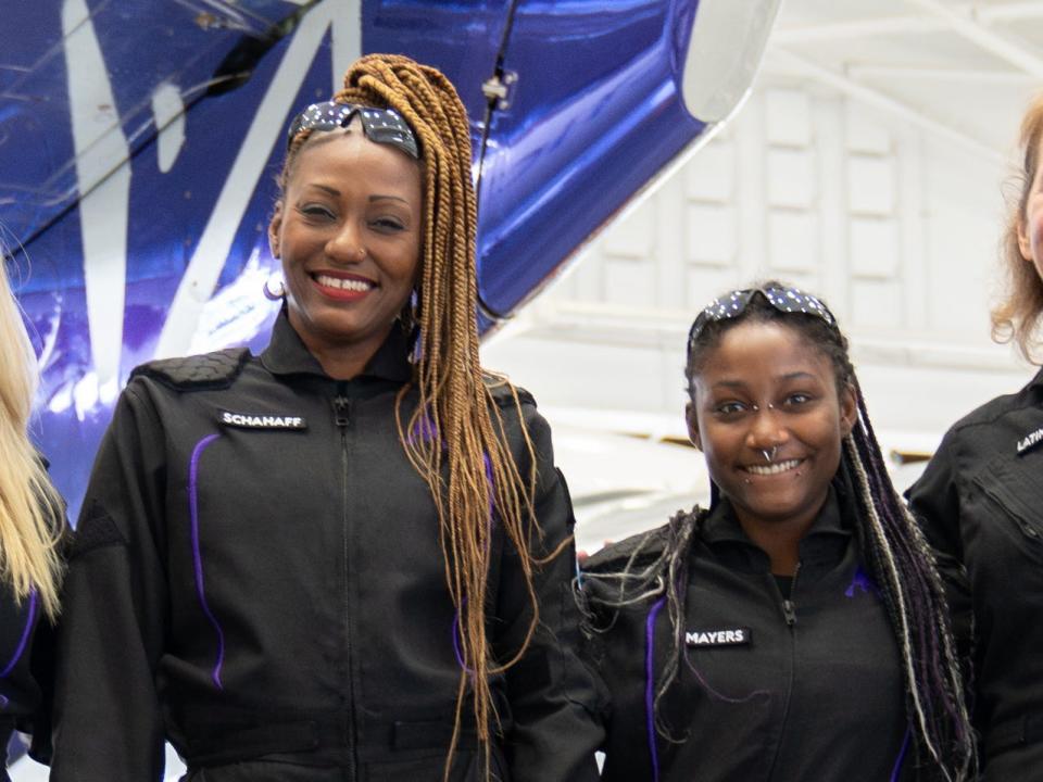 Four women due to fly on Virgin Galactic's Galactic 02 are posing in spacesuits in a flight hangar