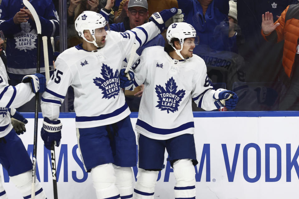 Toronto Maple Leafs left wing Nicholas Robertson (89), right, celebrates his goal with defenseman Mark Giordano (55) during the second period of an NHL hockey game against the Buffalo Sabres, Saturday, March 30, 2024, in Buffalo, N.Y. (AP Photo/Jeffrey T. Barnes)