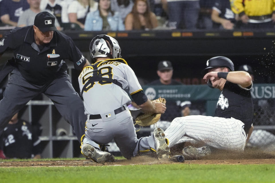 Pittsburgh Pirates catcher Jacob Stallings tags out Chicago White Sox's Gavin Sheets at home as umpire Brian O'Nora watches during the third inning of a baseball game Wednesday, Sept. 1, 2021, in Chicago. (AP Photo/Charles Rex Arbogast)