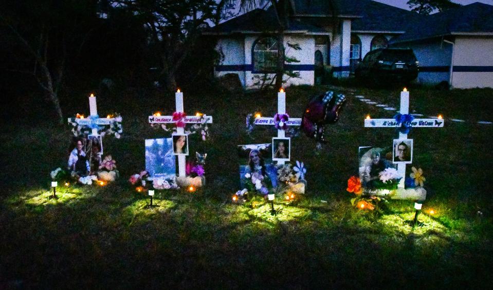 Four white crosses stand in the front yard of 4075 Alan Shepard Ave. in Canaveral Groves, the site of four fatal shootings in March. The crosses, illuminated by battery powered candles and solar lights, are adorned with photos of the victims, their names, ribbons and flowers.
(Credit: MALCOLM DENEMARK/FLORIDA TODAY)