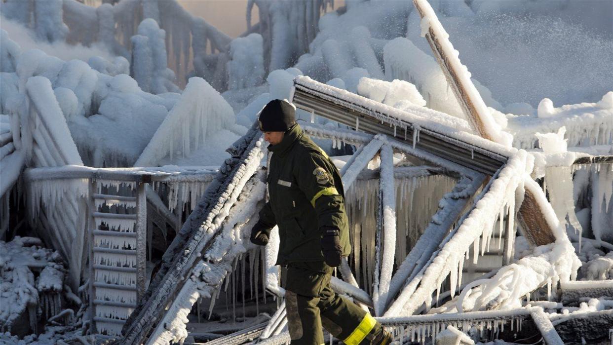 The seniors' home burned to the ground, killing 32 people on Jan. 23, 2014. The cold January temperatures iced over the wreck. (Ryan Remiorz/The Canadian Press - image credit)