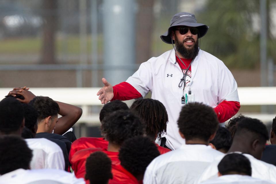 Immokalee football football head coach James Delgado talks with his players at the end of a spring practice, Wednesday, April 27, 2022, at Immokalee High School in Immokalee, Fla.