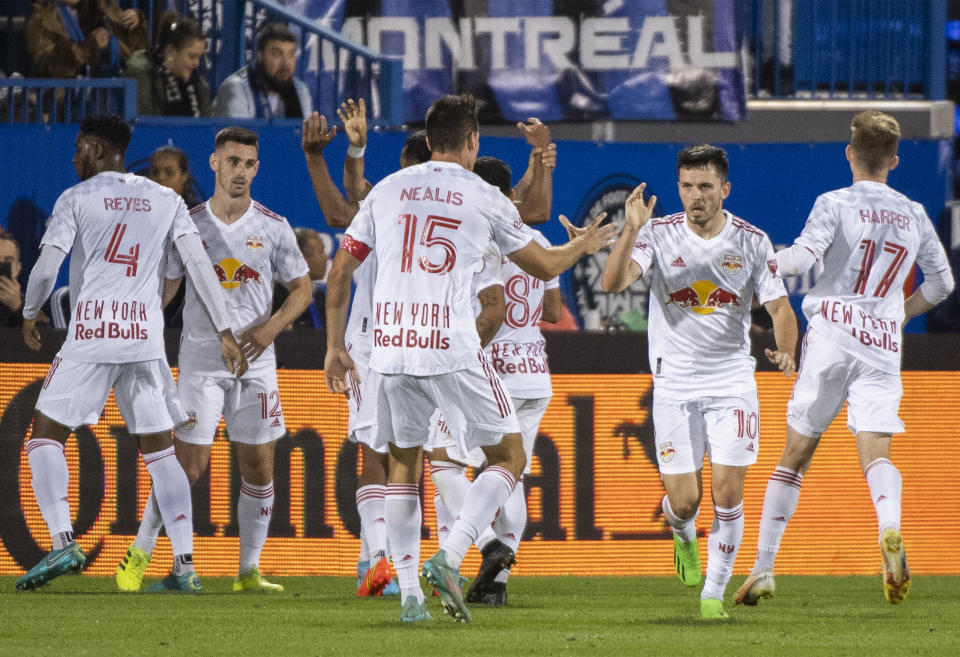 New York Red Bulls' Lewis Morgan (10) celebrates with teammates after scoring against CF Montreal during the first half of an MLS soccer match Wednesday, Aug. 31, 2022, in Montreal. (Graham Hughes/The Canadian Press via AP)