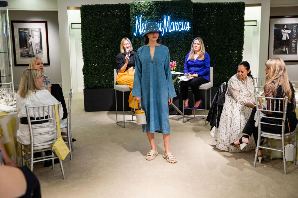 Lisa Aiken and local journalist Carolyne Zinko (background) talk, as models showcase the season&#x002019;s &#x00201c;must-haves&#x00201d; during a luncheon at the San Francisco flagship store. - Credit: Drew Altizer/courtesy photo