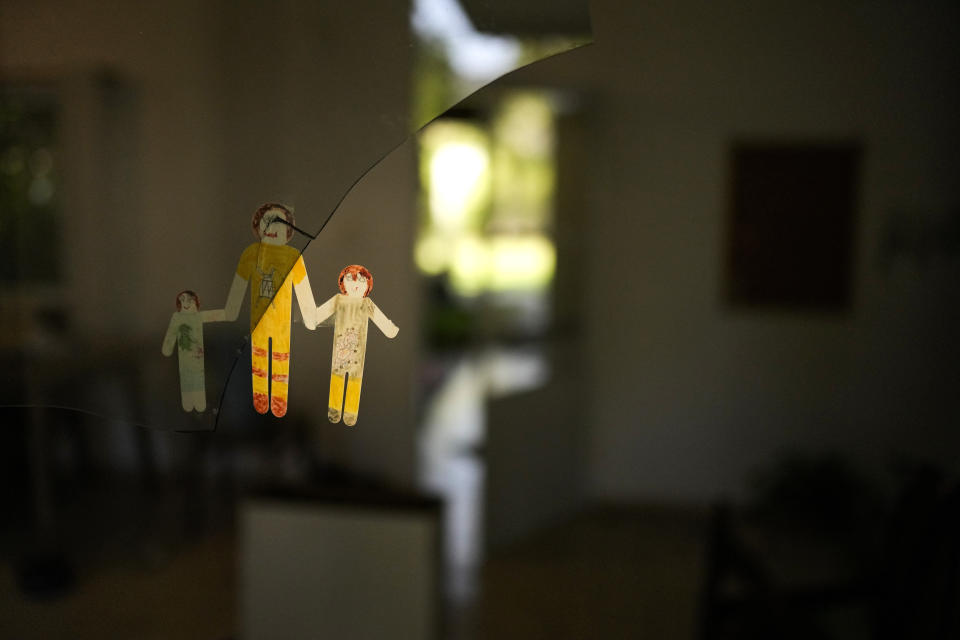A paper figure attached to a broken window in a home that came under attack during a massive Hamas invasion into Kibbutz Nir Oz, Israel, Thursday, Oct. 19, 2023. The small farming community in the south of Israel was overrun by Hamas fighters from the nearby Gaza Strip who killed 1,400 Israelis and captured dozens of others on Oct. 7. (AP Photo/Francisco Seco)
