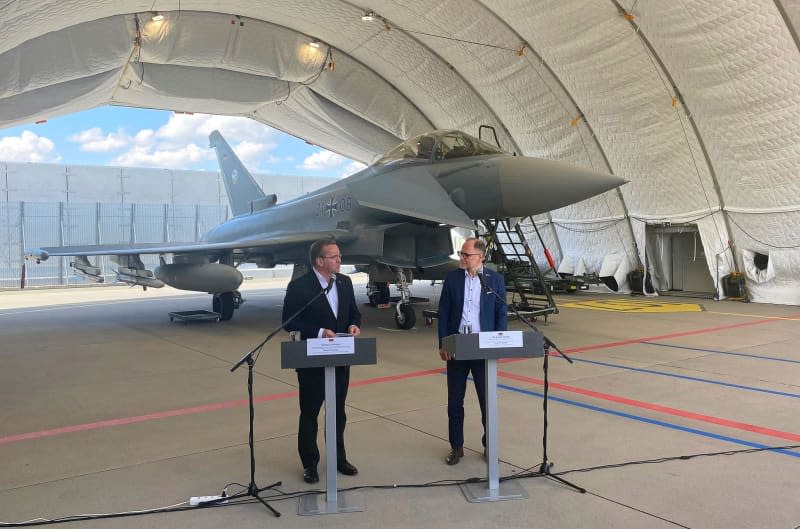 German Defence Minister Boris Pistorius  (L) and Latvian Minister of Defense Andris Spruds speak during a press conference at the Latvian Air Force Base Lielvarde in front of a German Air Force Eurofighter. Alexander Welscher/dpa