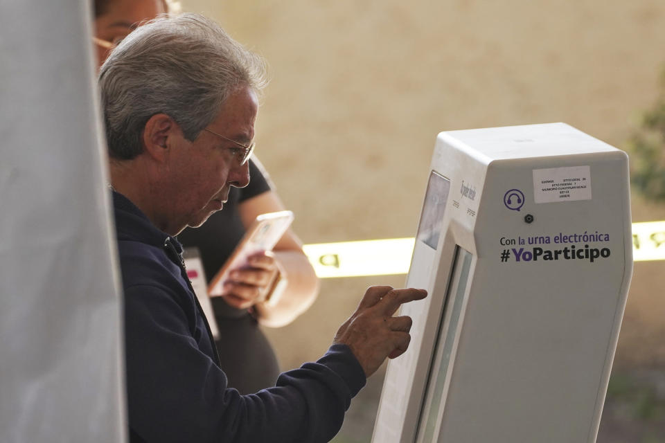 A man casts his ballot during the local state elections in Cuautitlán Izcalli, Mexico state, Mexico, Sunday, June 4, 2023. (AP Photo/Marco Ugarte)