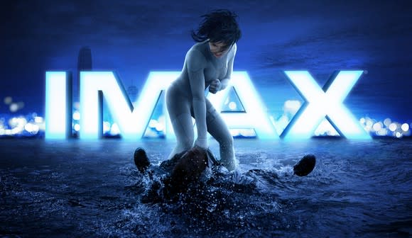 An IMAX ad for Ghost in the Shell with a woman standing over a person lying face up in water.