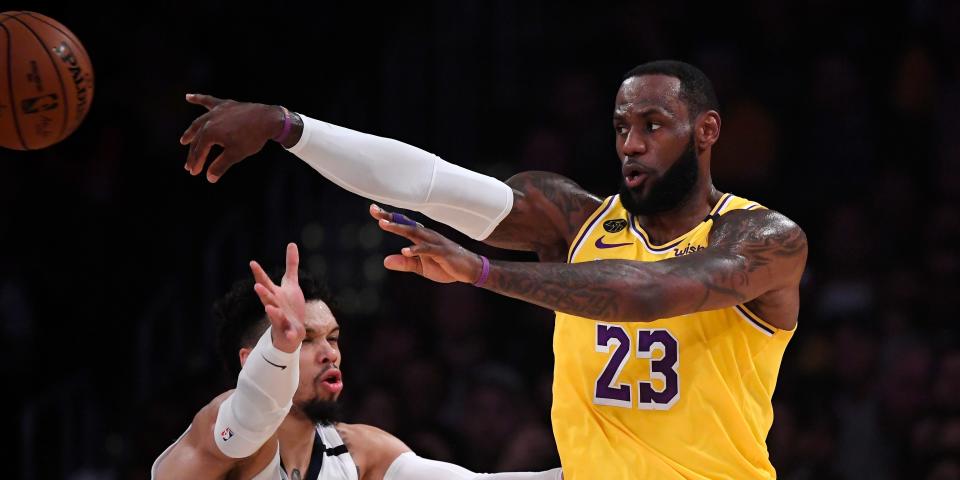 Los Angeles Lakers forward LeBron James, right, passes while under pressure from Memphis Grizzlies guard Dillon Brooks during the first half of an NBA basketball game Friday, Feb. 21, 2020, in Los Angeles. (AP Photo/Mark J. Terrill)