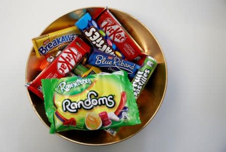 FILE PHOTO: Nestle confectionary products - including BreakAway, KitKat, Smarties, Blue Riband, Fruit Pastilles and Randoms - are seen in a bowl at the company's Product Technology Centre in York, Britain, March 21, 2018.  REUTERS/Phil Noble/File Photo