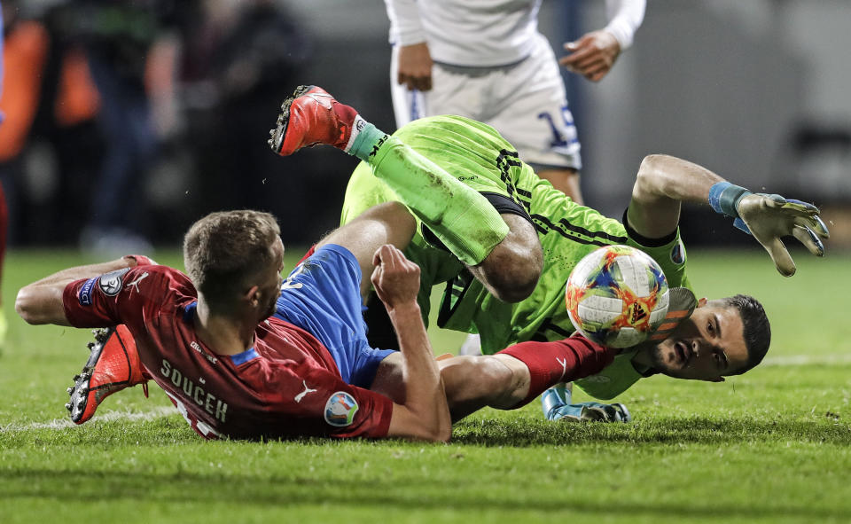 Czech Republic's Tomas Soucek, left, and Kosovo's keeper Arijanet Muric challenge for the ball during the Euro 2020 group A qualifying soccer match between Czech Republic and Kosovo in Pilsen, Czech Republic, Thursday, Nov. 14, 2019. (AP Photo/Petr David Josek)