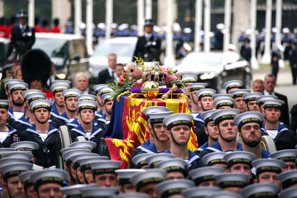 The State Gun Carriage carries the coffin of Queen Elizabeth II, draped in the Royal Standard with the Imperial State Crown and the Sovereign's orb and sceptre, in the Ceremonial Procession during her State Funeral at Westminster Abbey, London. Picture date: Monday September 19, 2022.