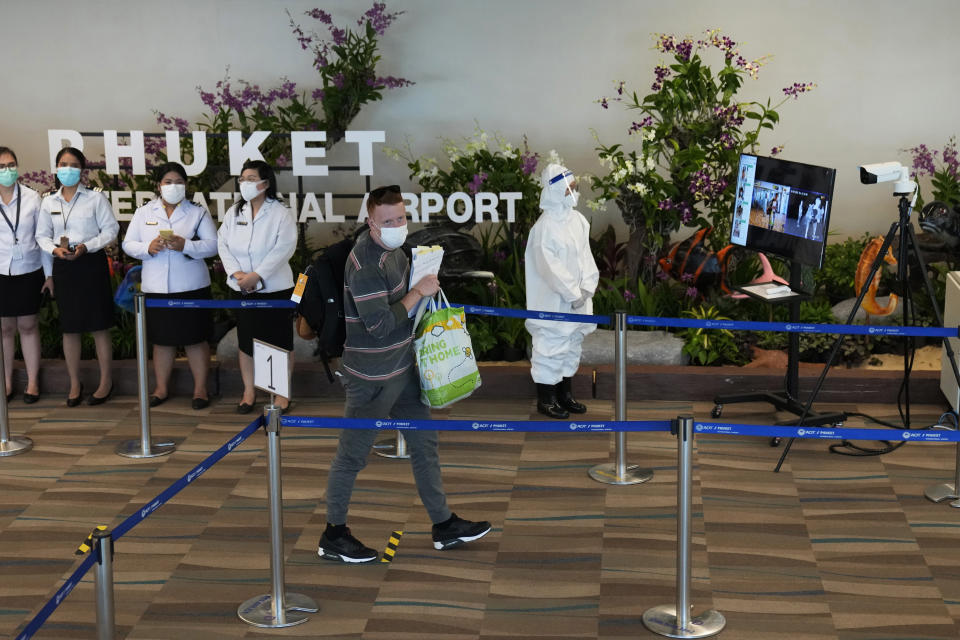 The first group of tourists from Abu Dhabi arrives at the Phuket International Airport in Phuket, Thailand, Thursday, July 1, 2021. Starting Thursday, Thailand will welcome back international visitors — as long as they are vaccinated — to its famous southern resort island of Phuket without having to be cooped up in a hotel room for a 14-day quarantine. (AP Photo/Sakchai Lalit)