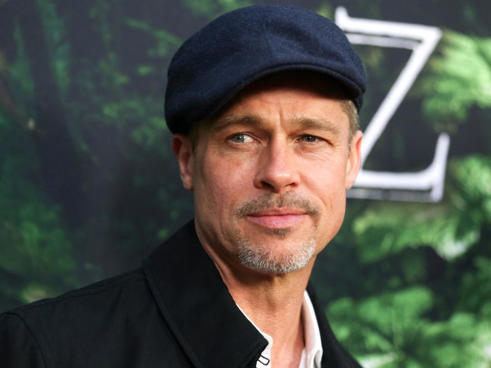 Brad Pitt wears a black hat