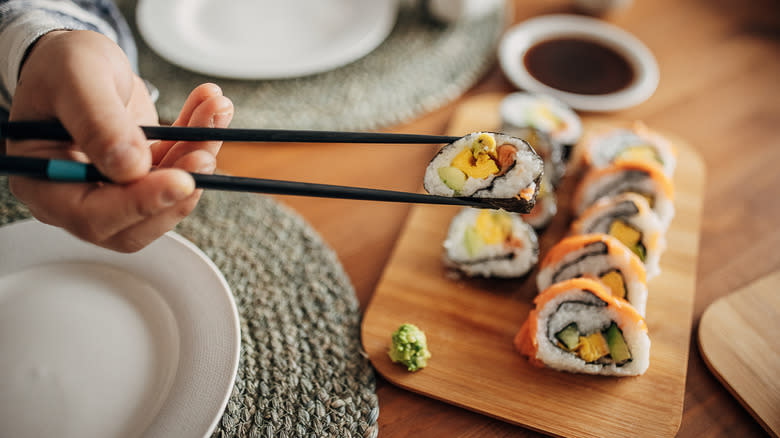 eating sushi with chopsticks