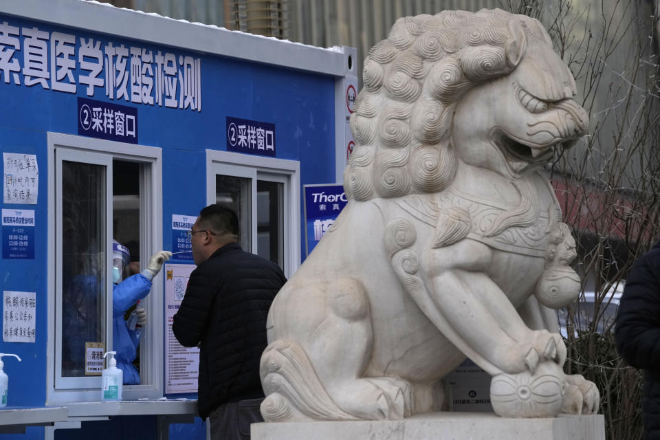 A man takes a COVID-19 test at a testing site in Beijing on Feb. 28, 2022. China's ruling Communist Party is temporarily turning away from its longer-term ambitions to focus on pulling the economy out of a slump as the country heads into the annual meeting of its ceremonial legislature. (AP Photo/Ng Han Guan)