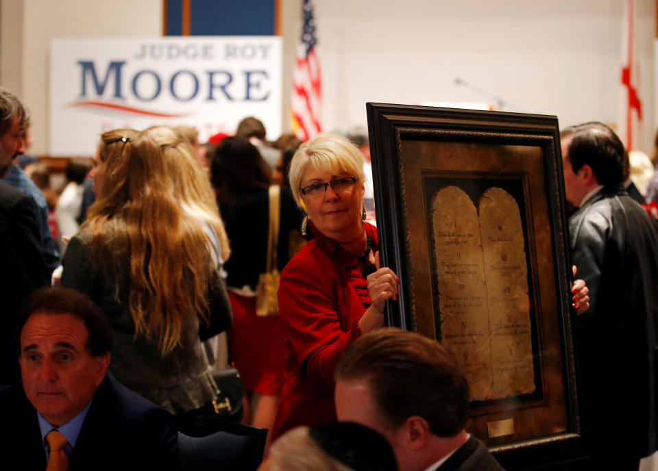 &nbsp;A framed Ten Commandments is being carried by a supporter at Republican Roy Moore's election party in Montgomery, Alabama, U.S., December 12, 2017.&nbsp; (Photo: Jonathan Bachman / Reuters)