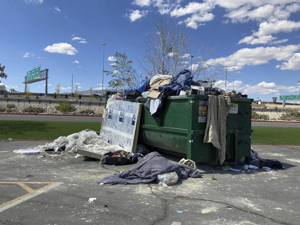 An overflowing dumpster is seen in the Grand Sierra Resort and Casino parking lot in Reno, Nev., Wednesday, Sept. 6, 2023. More than 100 RVs, campers and converted buses were parked Wednesday afternoon as the last of the Burning Man celebrants made their way journey back from the Black Rock Desert 100 miles to the north. (AP Photo/Scott Sonner)
