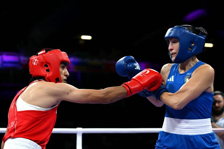 Algeria's Imane Khelif (in red) punches Italy's Angela Carini in the women's 66kg preliminaries round of 16 boxing match during the Paris 2024 Olympic Games at the North Paris Arena, in Villepinte on August 1, 2024. (Photo by MOHD RASFAN / AFP)