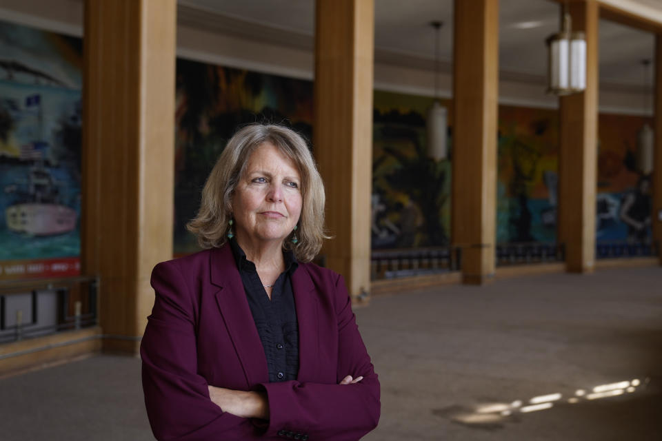 Sherry Williams, executive director of One Treasure Island, poses for a photo at her office on Tuesday, April 5, 2022, in San Francisco. Business Email Compromise scams are a type of crime where criminals hack into email accounts, pretend to be someone they're not and fool victims into sending money to places they aren't supposed to. In the case of Williams, the San Francisco nonprofit director, thieves hacked the email account of the nonprofit's bookkeeper then inserted themselves into a long email thread, sent messages asking to change the wire payment instructions for a grant recipient, and made off with $650,000. (AP Photo/Eric Risberg)