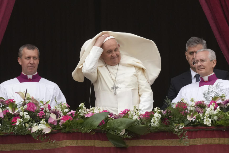 Pope Francis smiles from the central balcony of the St. Peter's Basilica prior to the 'Urbi et Orbi' (To the city and to the world) blessing, at the Vatican, Sunday, March 31, 2024. (AP Photo/Andrew Medichini)