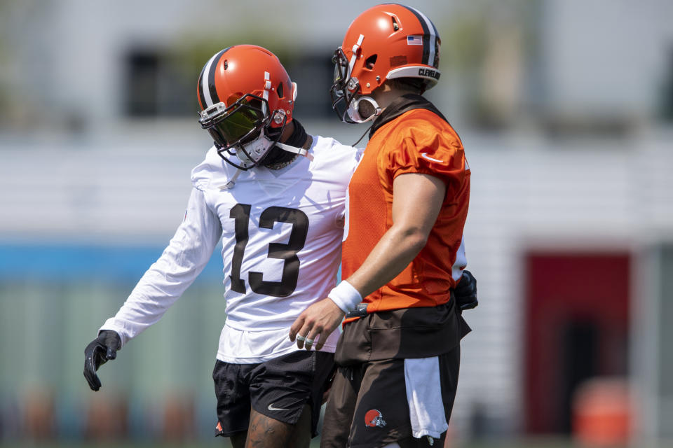 Cleveland Brows wide receiver Odell Beckham Jr., left, hugs quarterback Baker Mayfield (6) during NFL football practice in Berea, Ohio, Wednesday, July 28, 2021. (AP Photo/David Dermer)