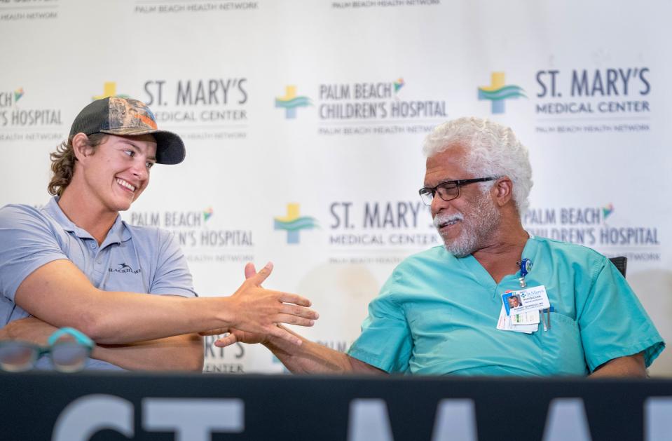 Shark bite survivor Marlin Wakeman, of Stuart, thanks trauma surgeon Dr. Robert Borrego during a press conference at St. Mary's Medical Center on May 9, 2024 in West Palm Beach, Florida. Wake was bitten by Carribbean reef sharks after he slipped and fell into the water in the Bahamas. He treated for his leg and shoulder bites at the medical center.