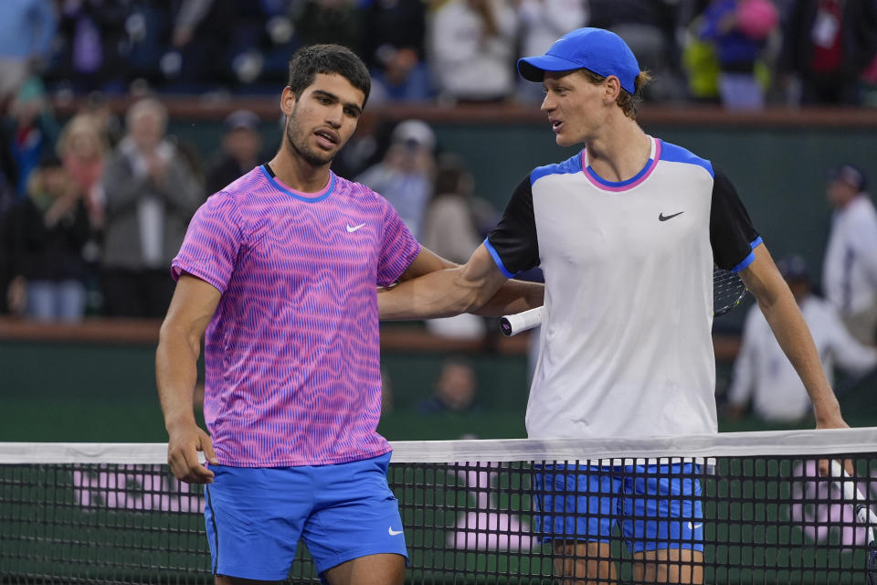 FILE - Carlos Alcaraz, of Spain, left, talks with Jannik Sinner, of Italy, after defeating him in a semifinal match at the BNP Paribas Open tennis tournament, Saturday, March 16, 2024, in Indian Wells, Calif. Alcaraz is the defending champion and Sinner is the top-seeded man at Wimbledon, where play begins on Monday, July 1.(AP Photo/Ryan Sun)