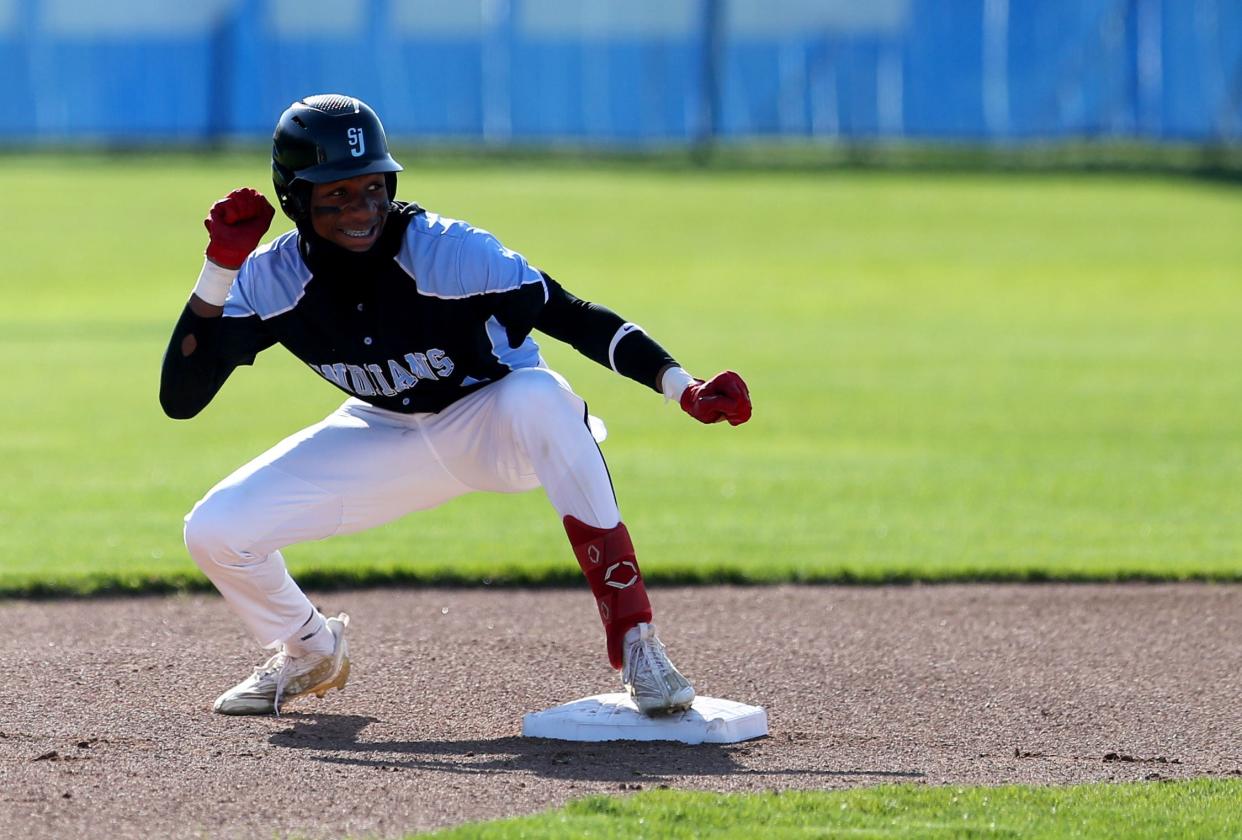 St. Joseph center fielder Jayce Lee (1) gestures to his bench after hitting into a double Tuesday, April 18, 2023, at the Marian-Saint Joseph boys baseball game in Mishawaka.