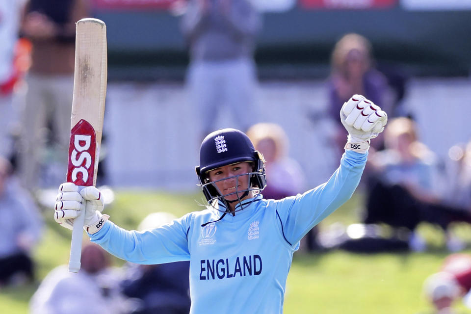 England's Danielle Wyatt celebrates making 100 runs against South Africa during their semifinal of the Women's Cricket World Cup cricket match in Christchurch, New Zealand, Thursday, March 31, 2022. (Martin Hunter/Photosport via AP)
