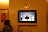 A nurse watches a TV broadcast in black and white of Thailand Prime Minister Prayuth Chan-ocha after King Bhumibol Adulyadej's death at a hospital in Bangkok, Thailand October 13, 2016. REUTERS/Stringer