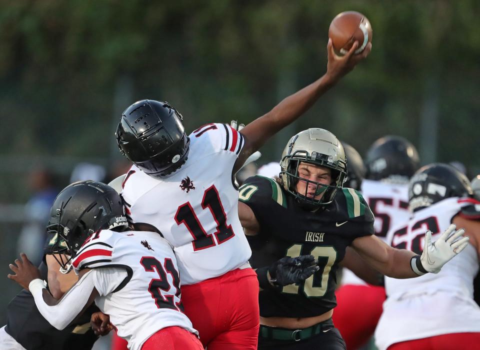 STVM defensive back Nathan Lenz, facing, attempts deflect a pass thrown by Buchtel quarterback Stevie Diamond during the first half of a high school football game, Friday, Sept. 9, 2022, in Akron, Ohio.