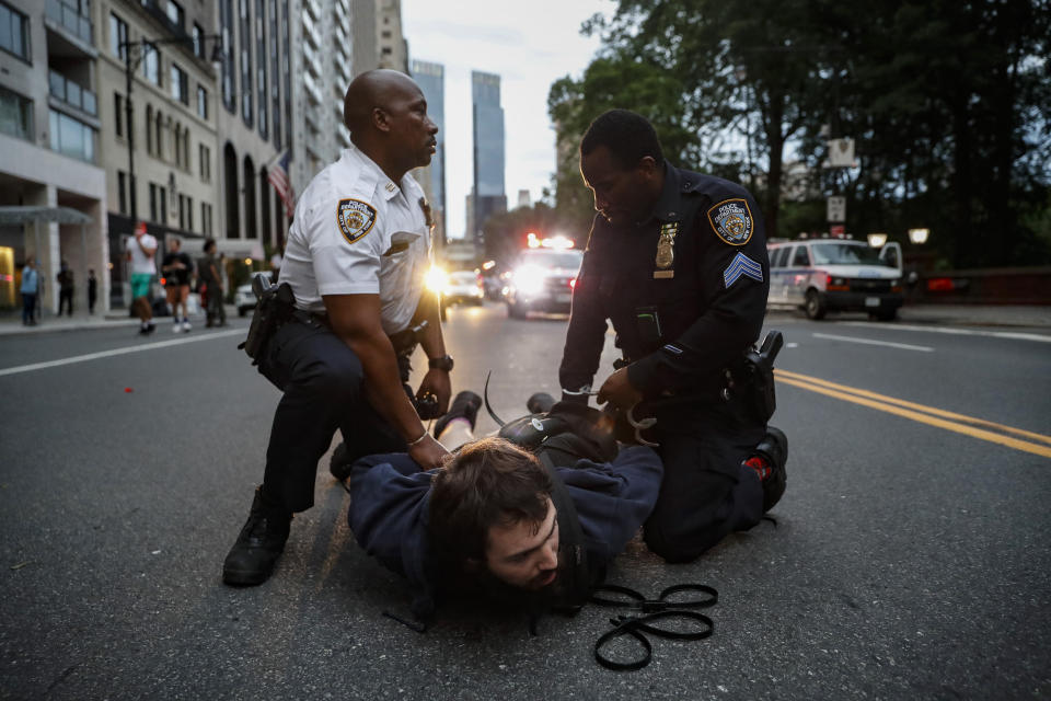 A protester is arrested for violating curfew near the Plaza Hotel on Wednesday, June 3, 2020, in the Manhattan borough of New York. Protests continued following the death of George Floyd, who died after being restrained by Minneapolis police officers on May 25. (AP Photo/John Minchillo)