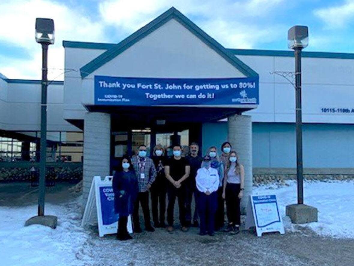 Staff at the Fort St. John Health Unit are pictured outside a Northern Health vaccination clinic at 10115-110 Ave. in Fort St. John. Northern Health authority is urging people hoping to get another dose of the COVID-19 to use its own website to locate vaccine sites. (Northern Health - image credit)