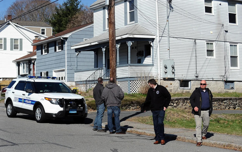 Investigators at the scene of 32 Glines Ave. in Milford on April 6, 2020, the day after a man was fatally shot by a police officer.