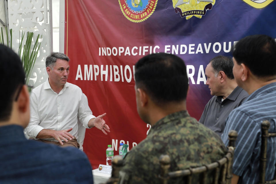 In this photo released by the Philippine DND Defense Communications Service and AFP Public Affairs Office, Australian Defence Minister Richard Marles, left, speaks with Philippine National Defense Secretary Gilberto Teodoro Jr., before a large-scale combined amphibious assault exercise on Friday, Aug. 25, 2023 at a naval base in San Antonio, Zambales. Australian and Filipino forces, backed by U.S. Marines, practiced retaking an island seized by hostile forces in a large military drill Friday on the northwestern Philippine coast facing the disputed South China Sea.(Philippine DND Defense Communications Service and AFP Public Affairs Office via AP)