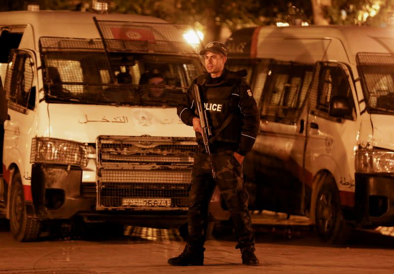 A police officer stands guard near the interior ministry in Tunis