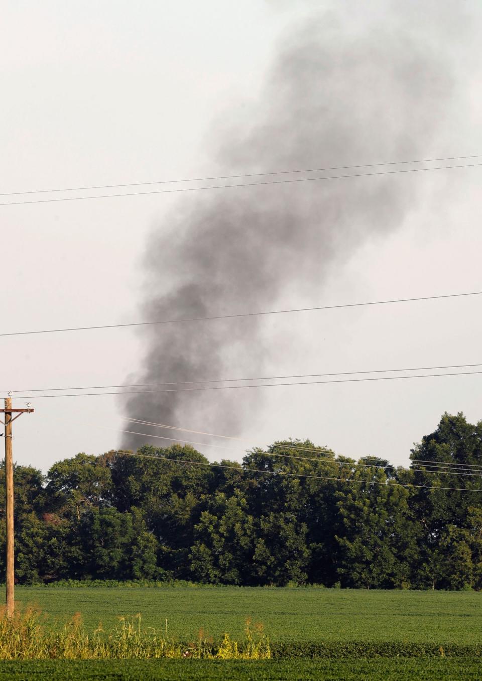 <p>Smoke rises in the air after a military transport plane crashed into a field near Itta Bena, Miss., on the western edge of Leflore County, as seen from U.S. Highway 82, Monday, July 10, 2017. Several were killed in the crash. (Photo: Andy Lo/AP) </p>