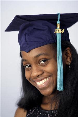 Grace Bush poses in her university graduation cap at her home in West Park, Florida, May 6, 2014. REUTERS/Andrew Innerarity