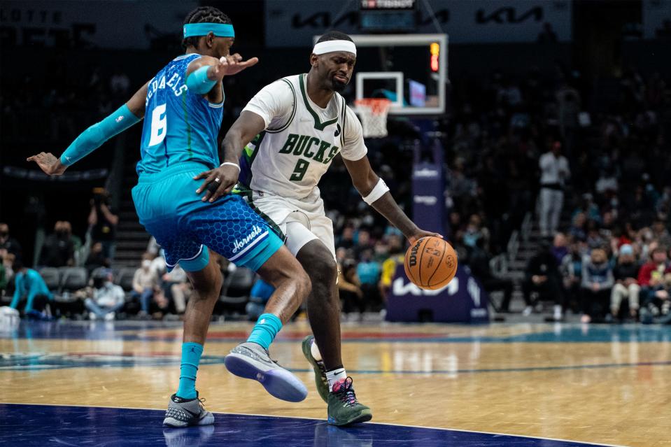 Bucks center Bobby Portis is defended by Hornets forward Jalen McDaniels on Saturday night. Portis finished with 19 points and 13 rebounds.