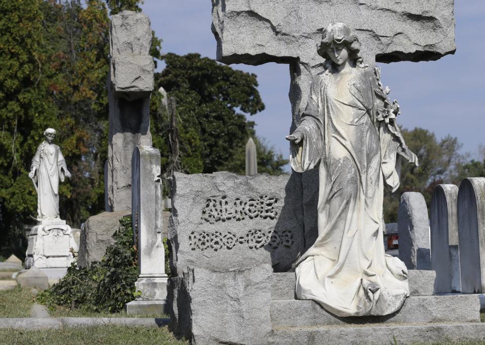 This Oct. 1, 2013 photo shows graves of some of the 80,000 people buried in Hollywood Cemetery on the James River near downtown Richmond, Va. The cemetery opened in 1849 and has grown to more than 135 acres with more than 80,000 people buried there, including Presidents James Monroe and John Tyler, as well as Confederate President Jefferson Davis and numerous Virginia governors. (AP Photo/Steve Helber)